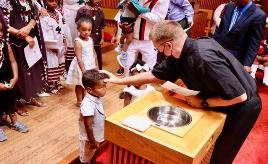 Two children baptized by Rev. Eric Sahlberg